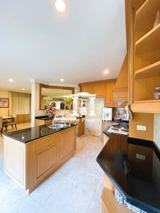 Modern kitchen with wooden cabinets and black countertops