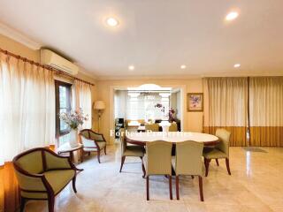 Spacious dining room with table, chairs, and well-lit ambiance