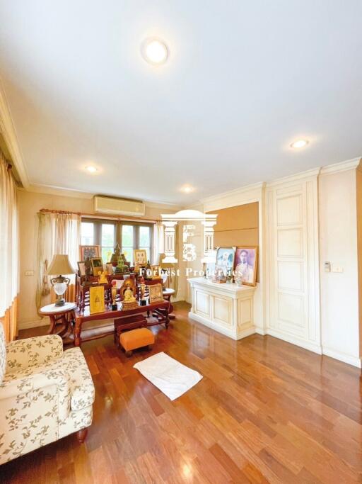 Living room with wooden floors and multiple light fixtures