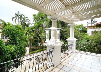 Spacious balcony with tiled floor and pergola-style roof