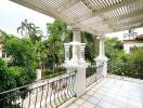 Spacious balcony with tiled floor and pergola-style roof