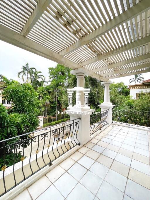 Spacious balcony with tiled floor and pergola-style roof