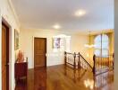 Second floor landing area with wooden flooring and staircase