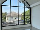 Living area with large triangular window and chandelier