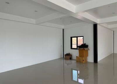 Spacious living room with white walls and glossy floors