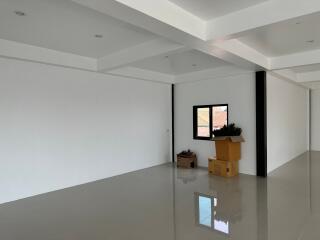 Spacious living room with white walls and glossy floors