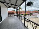 Spacious balcony with metal railing and outdoor seating