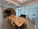 Modern meeting room with a wooden table, chairs, and multimedia setup