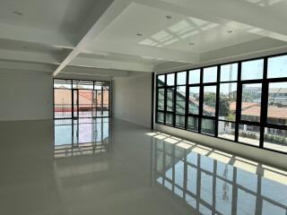 Spacious empty living area with large windows