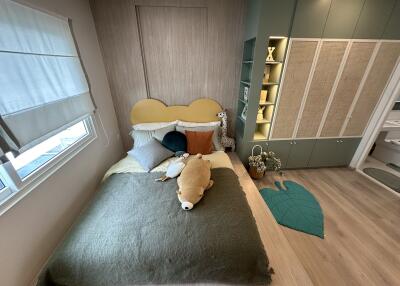 Modern cozy bedroom with built-in wardrobe and natural lighting