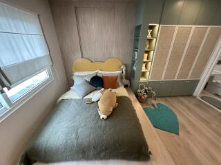 Modern cozy bedroom with built-in wardrobe and natural lighting