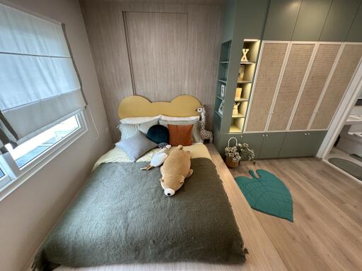 Modern cozy bedroom with built-in wardrobe and natural lighting