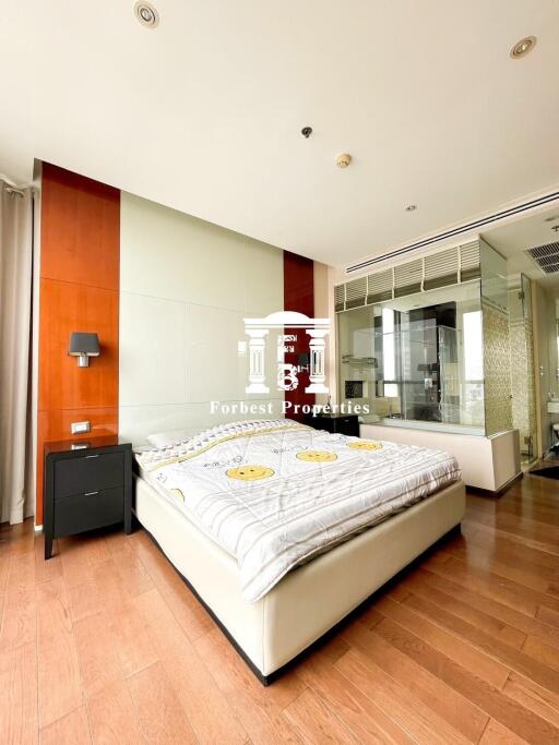 Modern bedroom with wooden flooring and glass wall