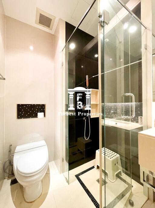 Modern bathroom with glass shower enclosure and toilet