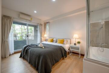 Spacious and well-lit bedroom with balcony access