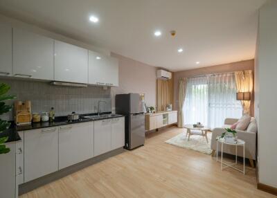 Modern kitchen and living area with natural lighting