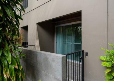 Outdoor view of a multi-story residential building with plants