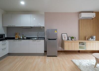 Modern kitchen and living area with appliances and decor