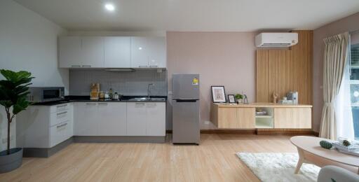 Modern kitchen and living area with appliances and decor