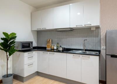 Modern kitchen with white cabinets and appliances