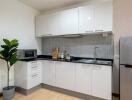 Modern kitchen with white cabinets and appliances