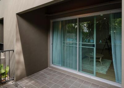 Outdoor balcony with tiled floor and sliding glass doors