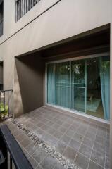 Outdoor balcony with tiled floor and sliding glass doors