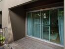 Outdoor balcony with tiled floor and sliding glass doors