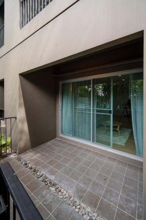 Outdoor balcony with tiled floor and sliding glass doors