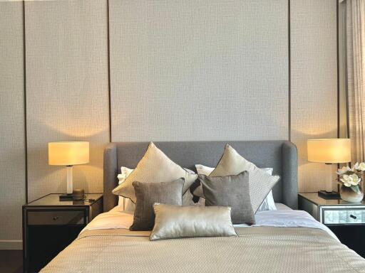 Modern bedroom with a stylish bed and bedside lamps