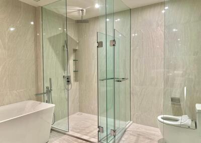 Modern bathroom with glass shower enclosure and freestanding bathtub