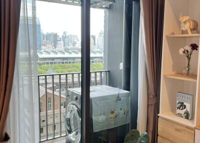 Laundry area with washing machine on balcony