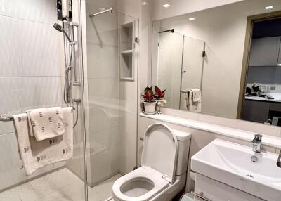 Modern bathroom with shower and large mirror