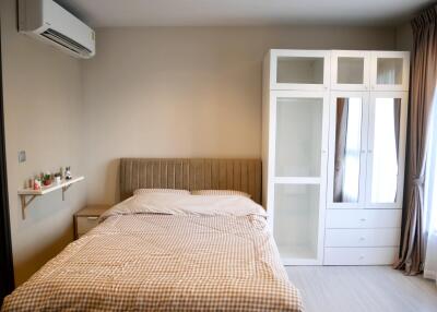 Modern bedroom with bed, wardrobe, and air conditioning