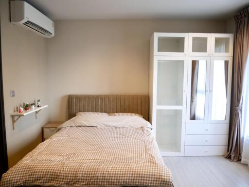 Modern bedroom with bed, wardrobe, and air conditioning