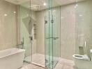 Modern bathroom with glass-enclosed shower, bathtub, and toilet