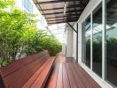 Outdoor patio area with wooden benches and greenery