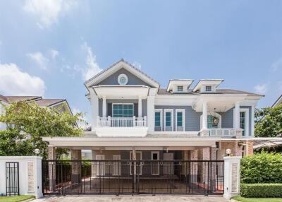 Front view of a modern two-story house with a gated driveway