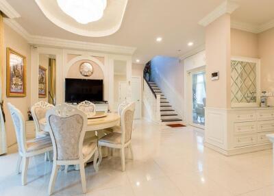 Elegant dining and living space with staircase