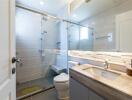 Modern bathroom with glass shower and wooden vanity