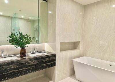 Modern bathroom with double sinks and bathtub