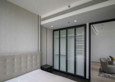Modern bedroom with a comfortable bed, large glass doors, and modern decor