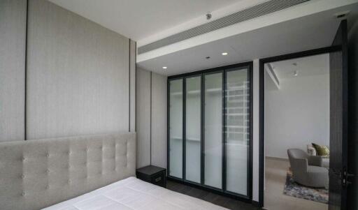 Modern bedroom with a comfortable bed, large glass doors, and modern decor