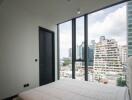 Modern bedroom with large windows and city view