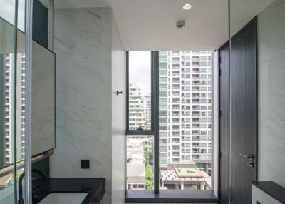 Modern bathroom with a large window and city view