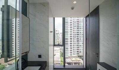 Modern bathroom with a large window and city view