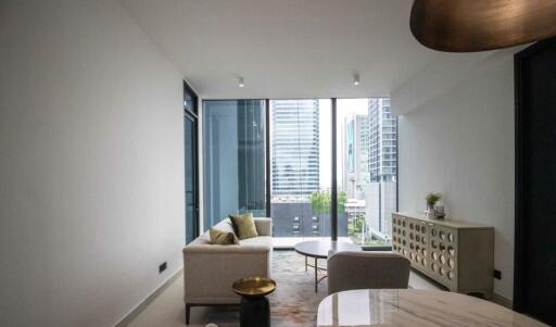 Modern living room with large windows offering city views