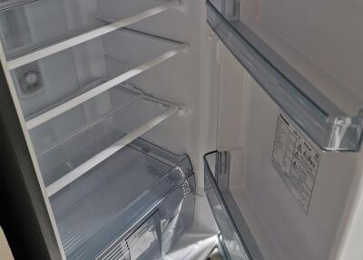 Open refrigerator showcasing empty shelves and door compartments