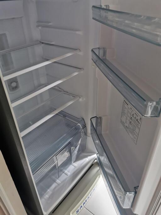 Open refrigerator showcasing empty shelves and door compartments