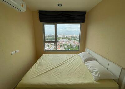 Bedroom with large window and city view